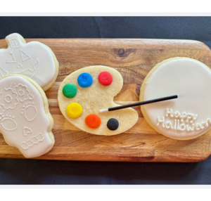 paint your own halloween cookies- skull, pumpkin, and freestyle cookie with paint palette cookie in middle with red, blue, green, yellow, orange, and black